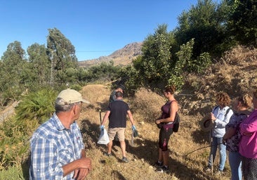 Local residents and Guardia Civil officers during a search which led to the discovery of the weapon in July.
