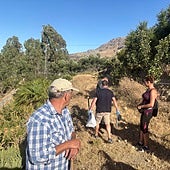 Local residents and Guardia Civil officers during a search which led to the discovery of the weapon in July.