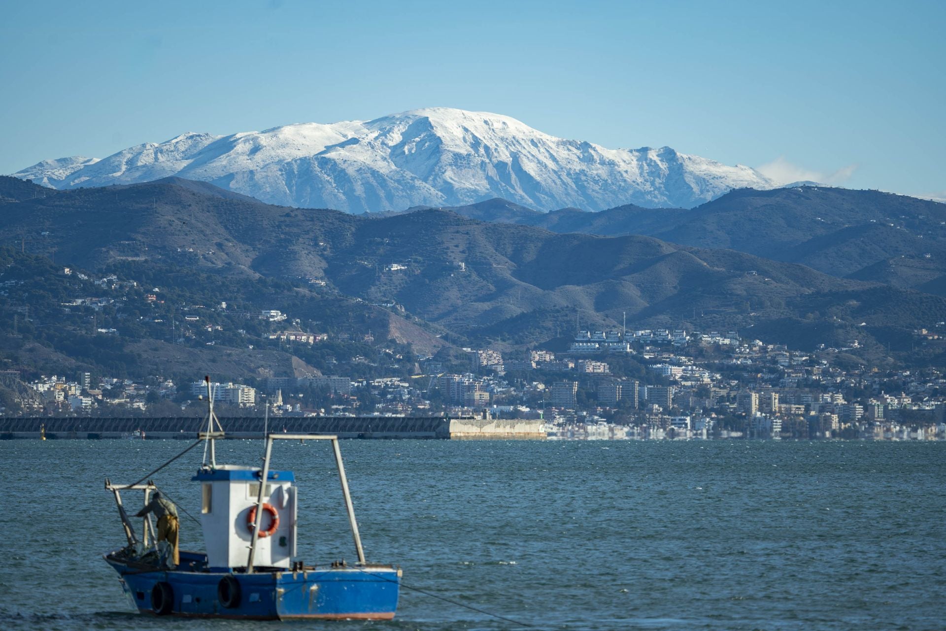 La Maroma mountain covered in snow, seen from the city of Málaga.