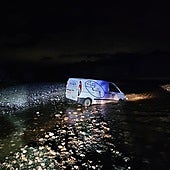 The van left the road and crashed into the riverbed.