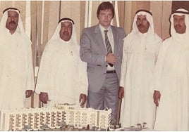 Grant Thomson and the four Al-Mailem brothers, with the model of the Hadi Center.