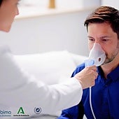 A doctor treats a man with asthma.