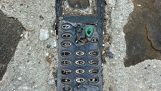 The mobile phone embedded in a pavement in a Malaga village