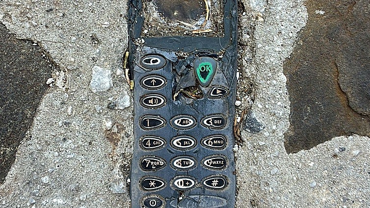 The mobile phone embedded in a pavement in a Malaga village