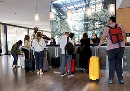 Guests wait at the reception of a hotel in Cordoba.