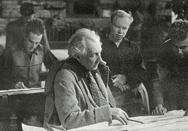 Architect Frank Lloyd Wright (centre), in his studio, with Robert Mosheron his left.