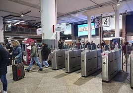 Passengers passing through Madrid-Puerta de Atocha train station.