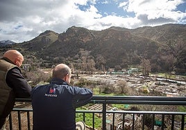Neighbours look at the ruined farmhouses in Quéntar.