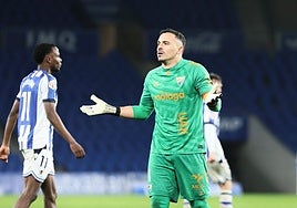 Malaga goalkeeper Alfonso Herrero complains that he was impeded.