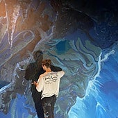 KIWI busy at workpainting the mural atAlmuñécar's aquarium