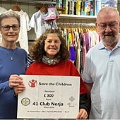 Angela and Alfie Fornear present the cheque to the Save the Children shop in Bath, UK