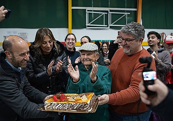 Pepe, a resident of Grazalema, turning 94 with a birthday cake in Ronda, following his town's evacuation.