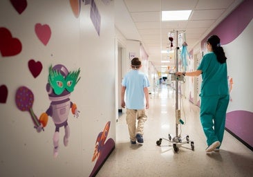 A nurse accompanies a child in the paediatric oncology ward of Hospital Materno in Malaga.