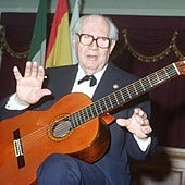 Andrés Segovia with a classical guitar.