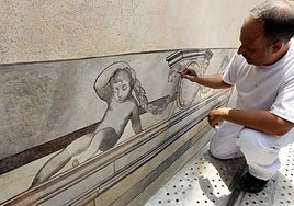 Restoration of mural paintings on the facade of a building in Malaga.