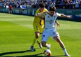 Marbella's Dani Selma protects the ball under pressure.