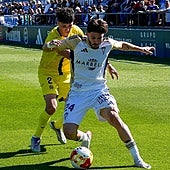 Marbella's Dani Selma protects the ball under pressure.