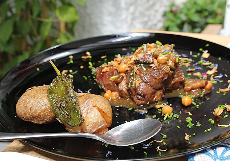 Beef cheek with demi-glace, chickpeas, spinach and potatoes.