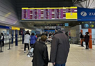 Couple checking the flight information display system at an airport.