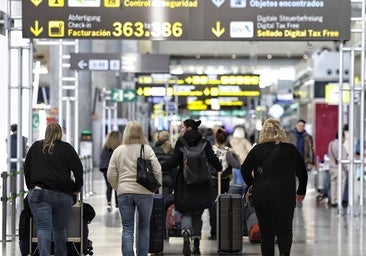 Passengers make their way to the check-in desks at Malaga Airport.