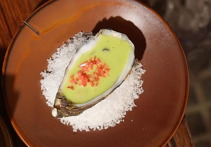 Amélie oysters served natural, with green lettuce gazpacho and pickled radishes.