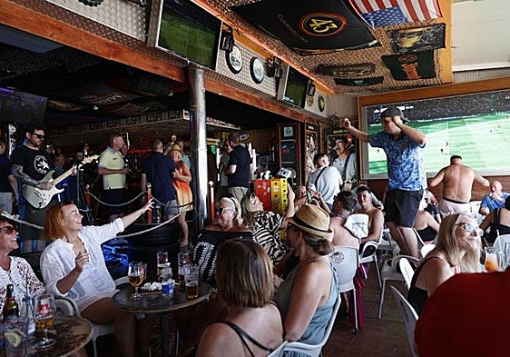 Football fans in a bar in Benidorm in 2024.