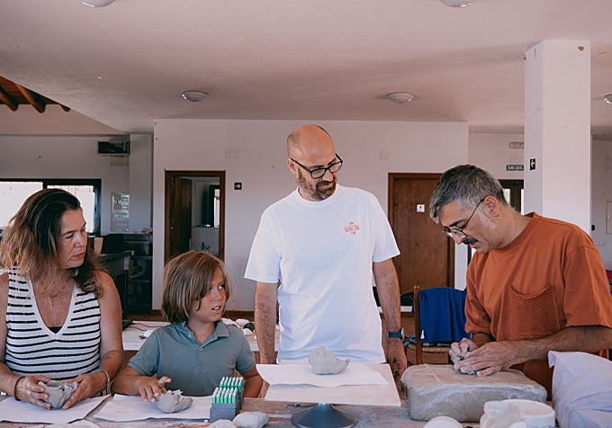 Pablo Bellot works with local residents to create ceramics featuring messages.