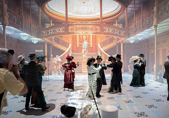 An immersive exhibition of The Legend of the Titanic, featuring people dressed in period costume for the presentation.