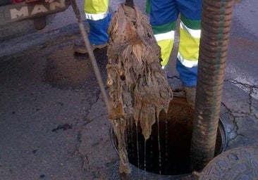 Wet wipes being removed from a drain in Malaga