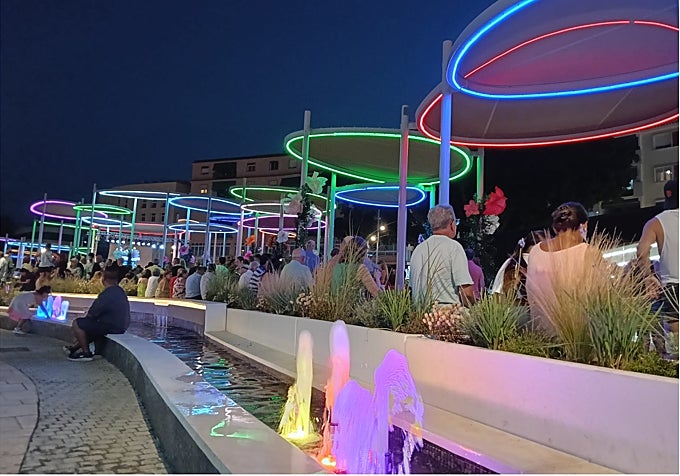 The new plaza incorporates Mediterranean landscaping and water features.