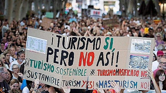 More than 100 people occupy Ibiza beach in overtourism protest