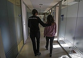 A National Police officer accompanying a woman who has just filed a gender-based violence complaint in Spain.