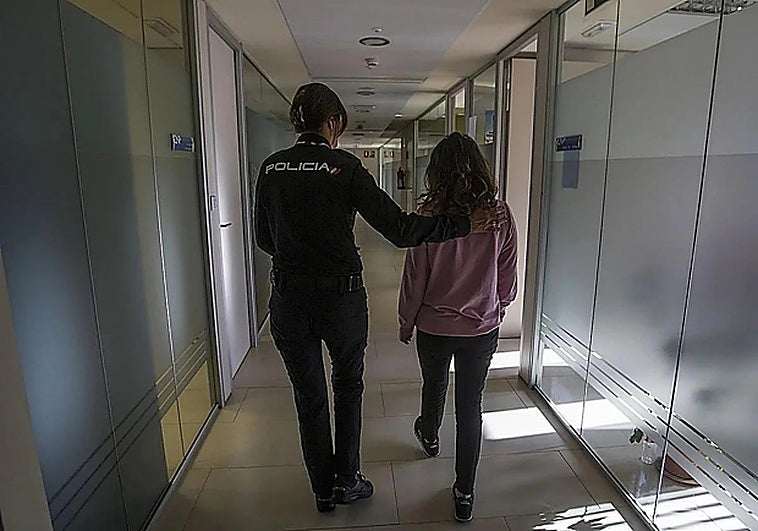 A National Police officer accompanying a woman who has just filed a gender-based violence complaint in Spain.
