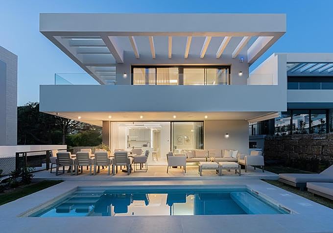 Indoor and outdoor spaces are designed by Miccoli Interiors as one continuous living environment at Villa La Vera in Marbella, where furniture, lighting and architecture work together throughout the home.
