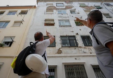 Two quantity surveyors are inspecting one of the oldest buildings in Santa Adela.