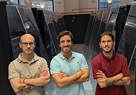 David Castaño, Felipe Romero and Javier Luque, alongside the PIcasso supercomputer, at Malaga University's supercomputing and bioinformatics centre.
