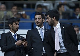 Rakan, centre, alongside his two brothers in the VIP box at La Rosaleda.