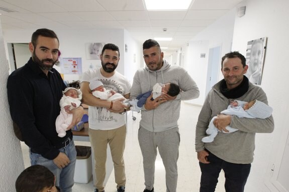 Four happy dads and their babies on the ward in Malaga's maternity hospital this week. :: f.g.