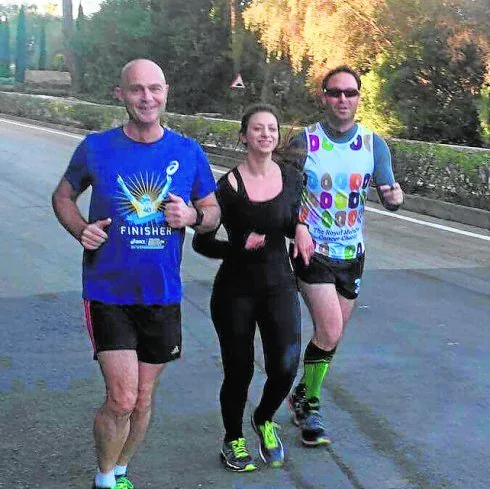 Simon (right) running in Sotogrande with his fiancée, Jessica, and friend, Stefan