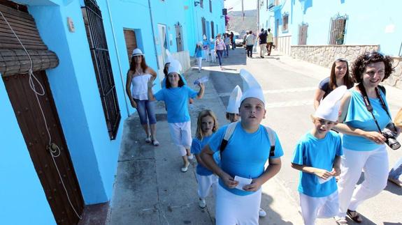 Youngsters enjoy the Smurf theme on the streets of Júzcar, near Ronda.