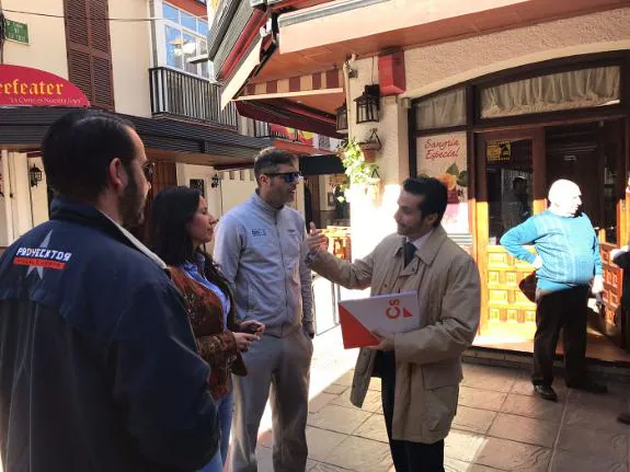 Javier Toro meets with local business owners on Fish Alley.