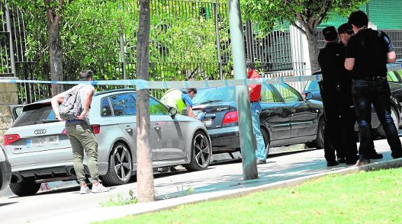 Investigators inspect the crime scene last Saturday.