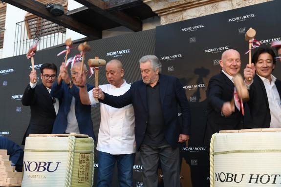 The co-founders of the Nobu group, taking part in the sake ritual at the hotel opening.