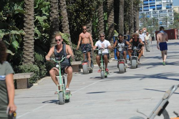 A growing craze for electric scootering- tourists on Marbella's paseo marítimo.
