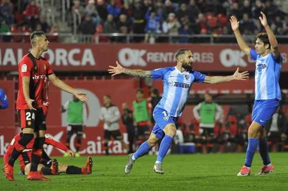 Cifu celebrates after his last-gasp strike puts Malaga ahead in Mallorca on Saturday night.
