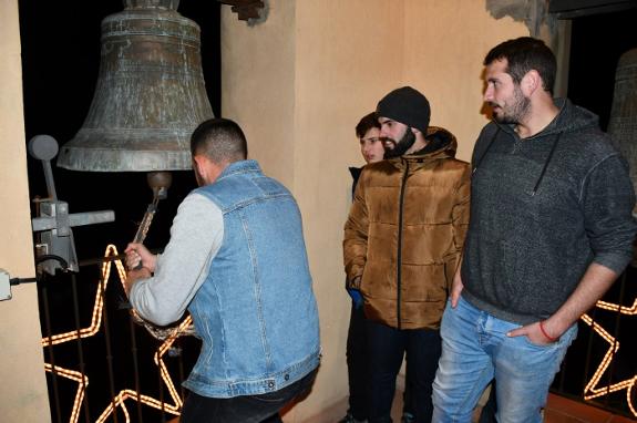 Ringing the bell in the church tower to wake up the residents.