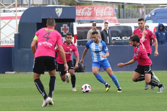 Hicham (centre) was Malagueño's main threat.