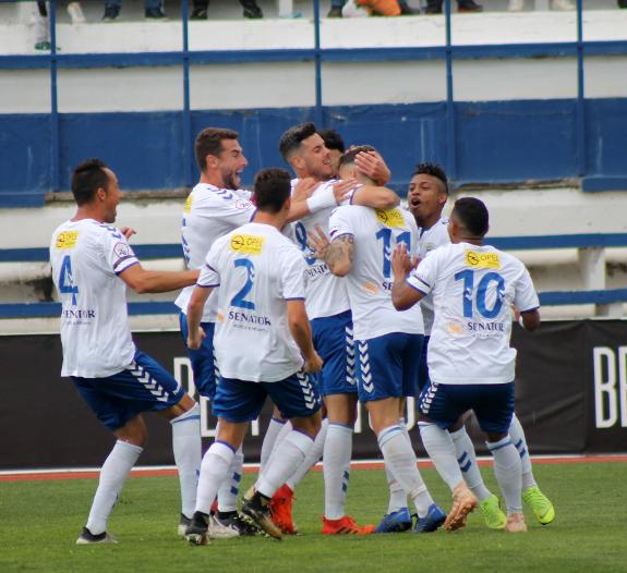 The Marbella players celebrate the opener. 