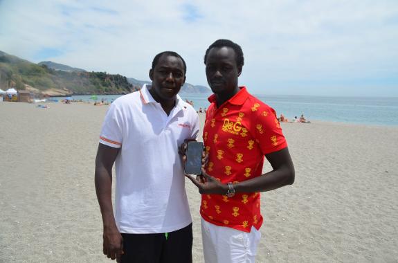 Moustapha and Makhtar Diop with a photo of their sister . 