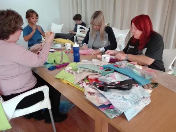 Janet Hassall (right) and volunteers put the doll bags together.